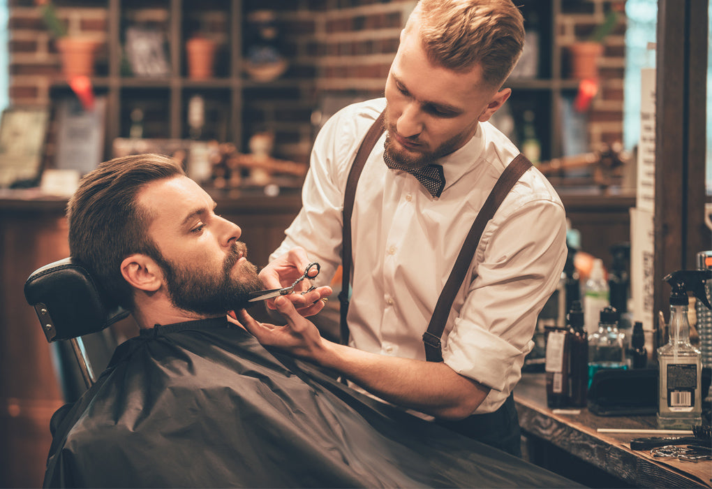 Barber trimming a beard in a barbershop - Mens Grooming - Beard Care Products made in Canada