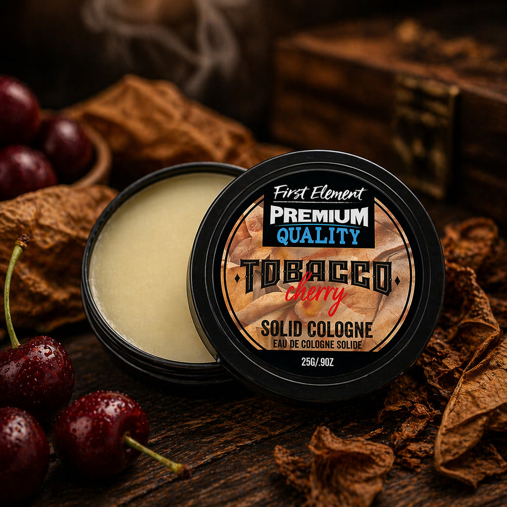 Solid cologne container labeled 'Tobacco Cherry' with cherries and tobacco leaves on a dark background