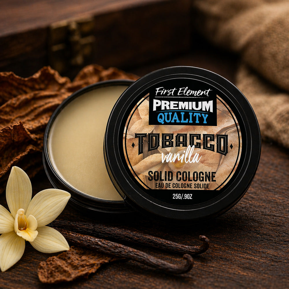 Solid cologne container labeled 'Tobacco Vanilla' with vanilla flower and vanilla bean on a wooden surface.