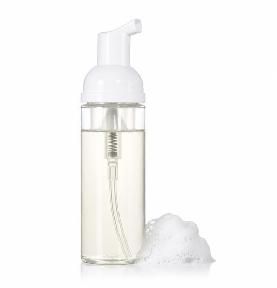 Foam soap dispenser with white pump and clear body on a white background